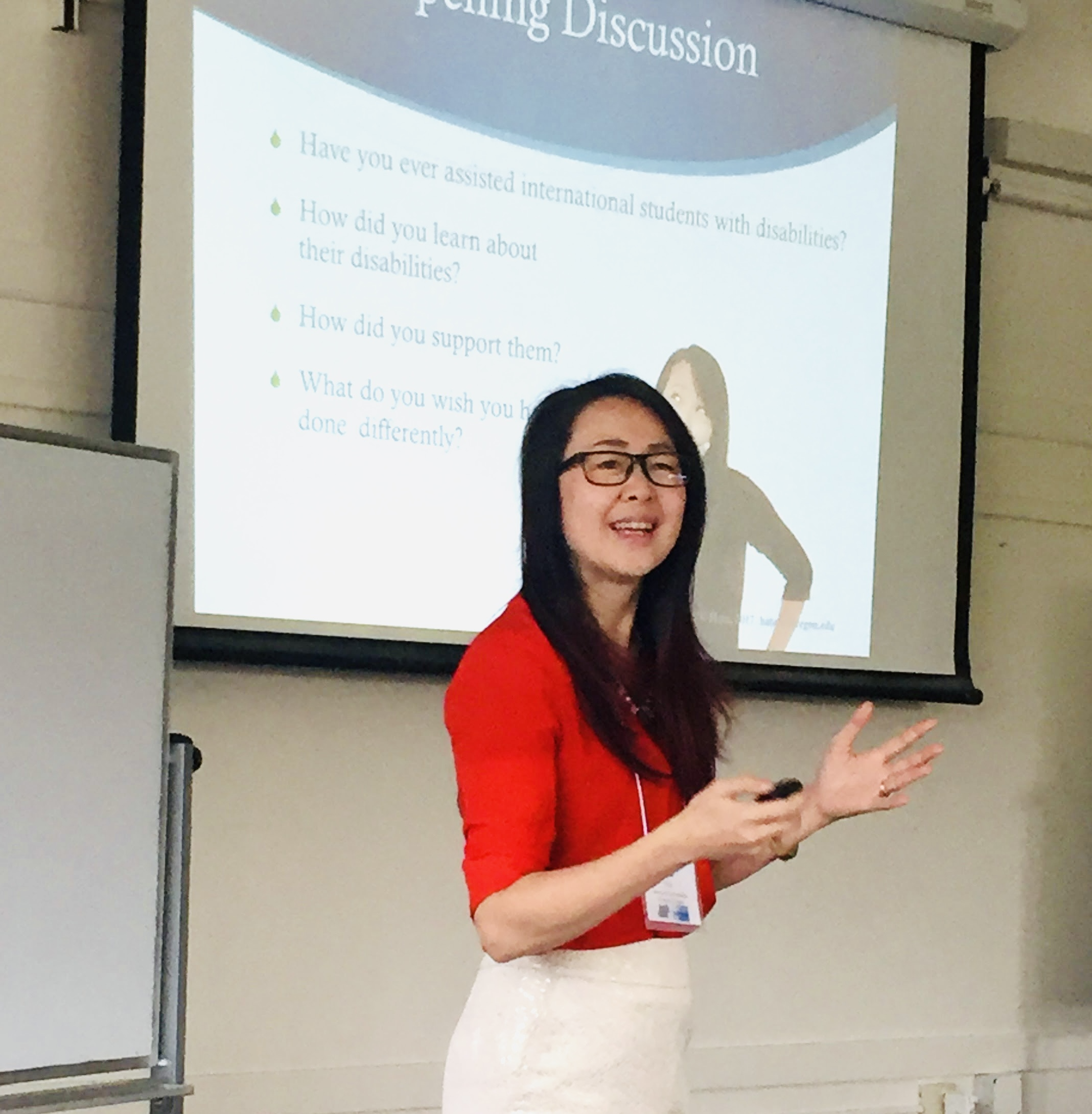 Maiko standing in front of a classroom speaking
